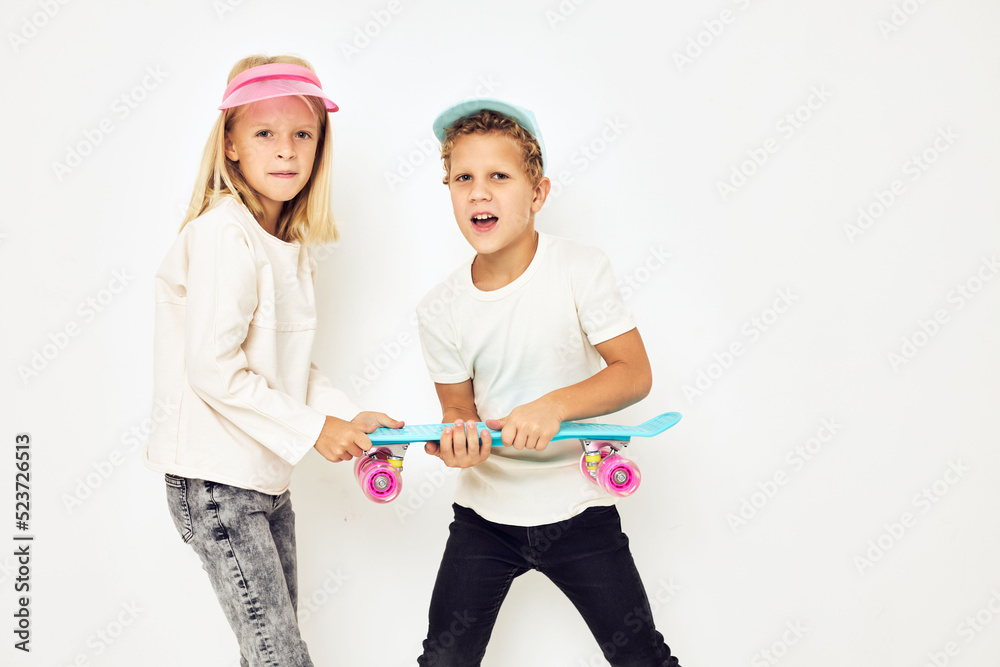 Modern teenagers posing together in caps with skateboard lifestyle childhood Modern teenagers posing together in caps with skateboard lifestyle childhood
