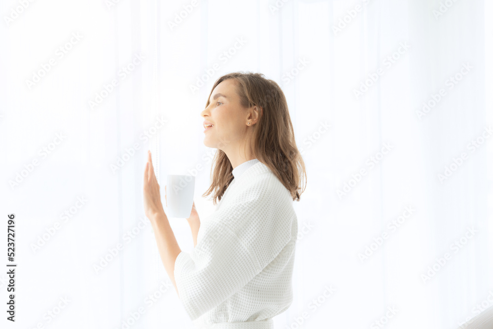 beautiful woman drinking coffee or milk in the morning by the window. view from outside. She drinking milk after wake up in the morning beautiful woman drinking coffee or milk in the morning by the window. view from outside. She drinking milk after wake up in the morning