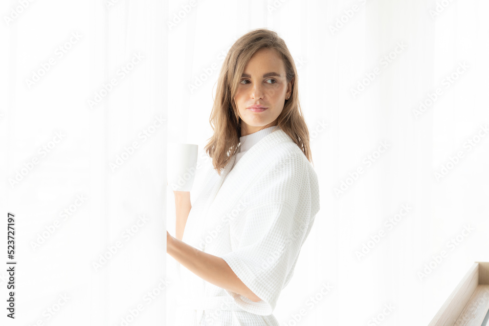 beautiful woman drinking coffee or milk in the morning by the window. view from outside. She drinking milk after wake up in the morning beautiful woman drinking coffee or milk in the morning by the window. view from outside. She drinking milk after wake up in the morning