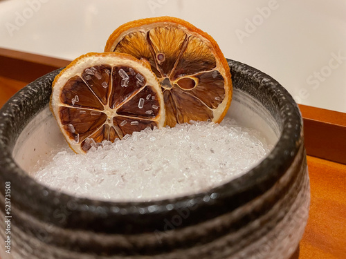 Dried oranges in bowl of bath salts close upview photo