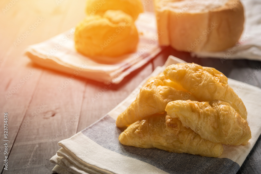 freshly baked croissants on wooden table background,  For breakfast and tea time.
.