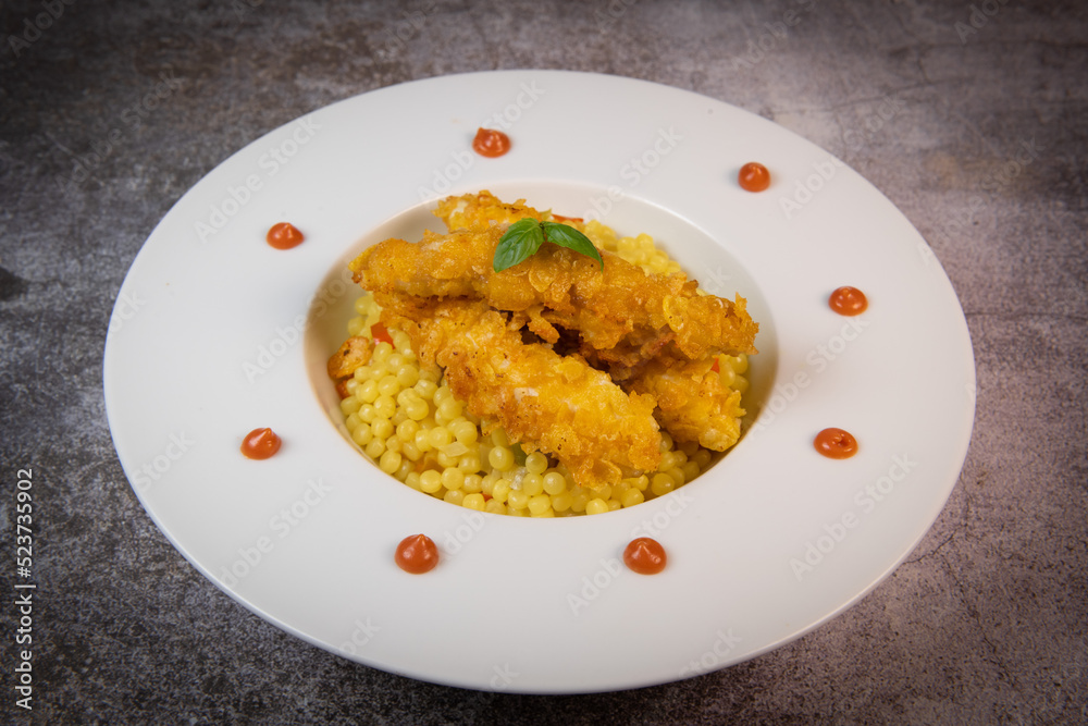 Recipe for chicken tenders with corn flakes and Italian Piombo pasta risotto and peppers. High quality photo Recipe for chicken tenders with corn flakes and Italian Piombo pasta risotto and peppers. High quality photo