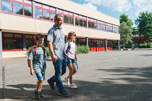 Dad accompanies or picks up children from school. Beginning of the school year, students go back to school © Elena Medoks