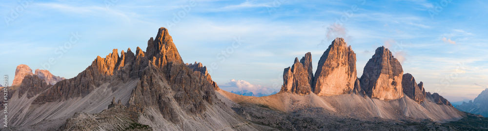Stunning panoramic view of the Three Peaks of Lavaredo (Tre cime di Lavaredo) during a beautiful sunset. The Three Peaks of Lavaredo are the undisputed symbol of the Dolomites, Italy..