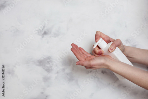 Slika na platnu Female hands using liquid soap