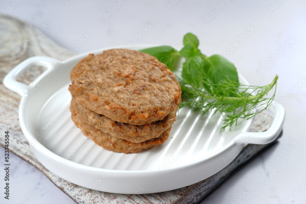 Burger meat patties with vegetables on white background. Burger meat patties with vegetables on white background.