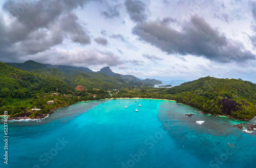 Aerial view of Mahe island with yachts, mountains and Indian Ocean in Seychelles