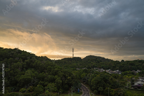 Aerial view of 5G Communication tower during morning sunrise with clouds, mists and fog
