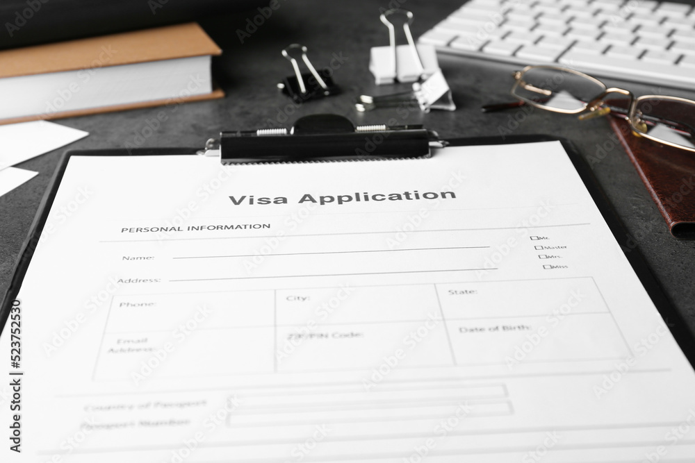 Visa application form for immigration and stationery on grey table, closeup Visa application form for immigration and stationery on grey table, closeup