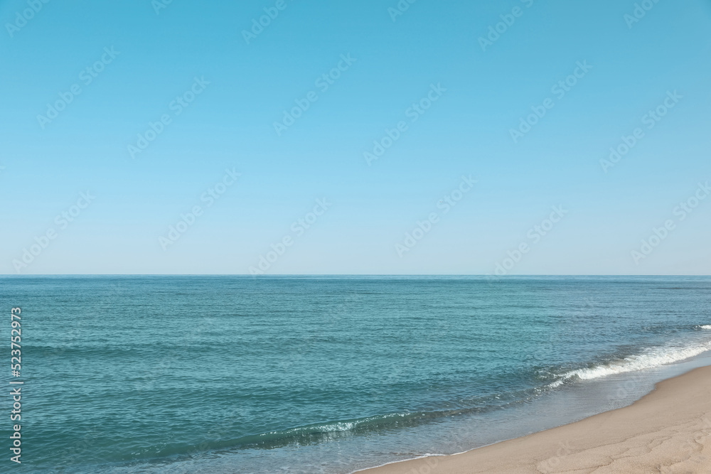 Beautiful view of sea shore under blue sky on sunny day Beautiful view of sea shore under blue sky on sunny day