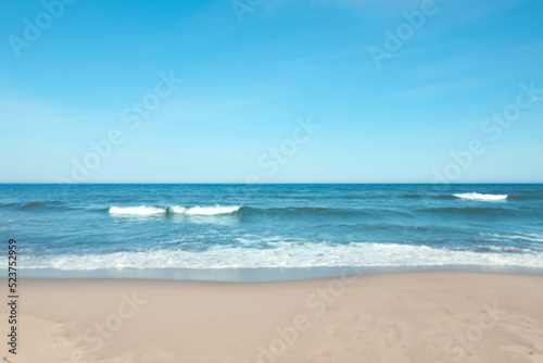 Fototapeta Naklejka Na Ścianę i Meble -  Blurred view of beautiful sea and sandy beach on sunny day