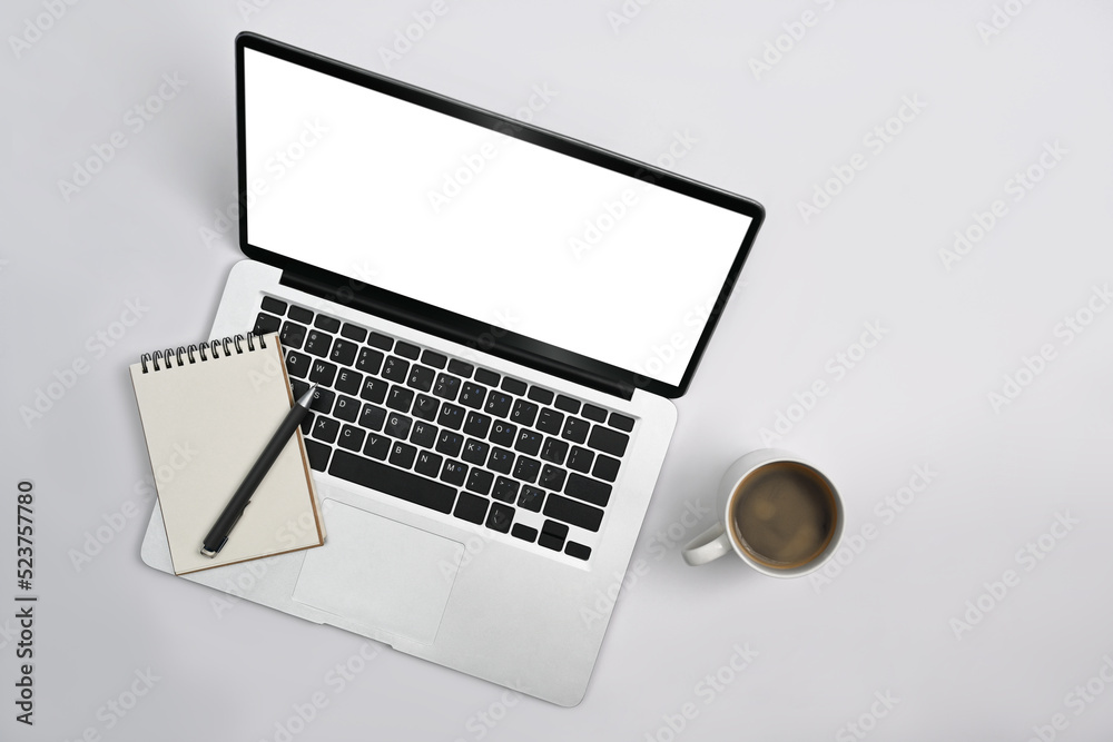 Top view laptop computer, notepad, coffee cup and succulent plant on office desk Top view laptop computer, notepad, coffee cup and succulent plant on office desk