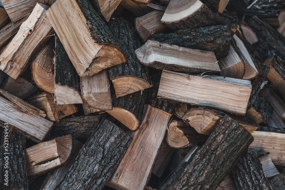 Wooden natural sawn logs as background, top view, flat lay. Wood texture. Firewood stack. Wooden natural sawn logs as background, top view, flat lay. Wood texture. Firewood stack.