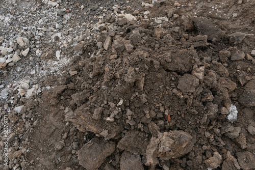 Pile of dark brown construction gardening soil mud land earth dirt heap pile mound, freshly dug