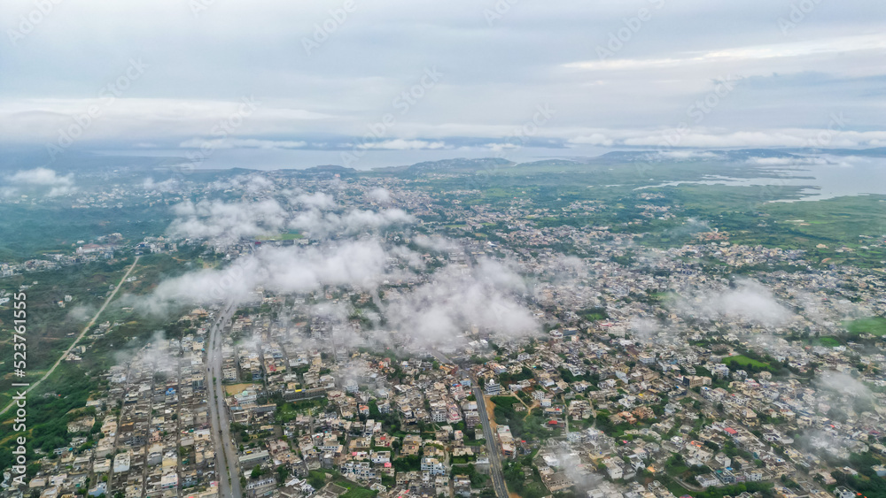 Aerial View of Mirpur Azad Kashmir city with fluffy clouds, Drone photography of Pakistan or India or South Asia