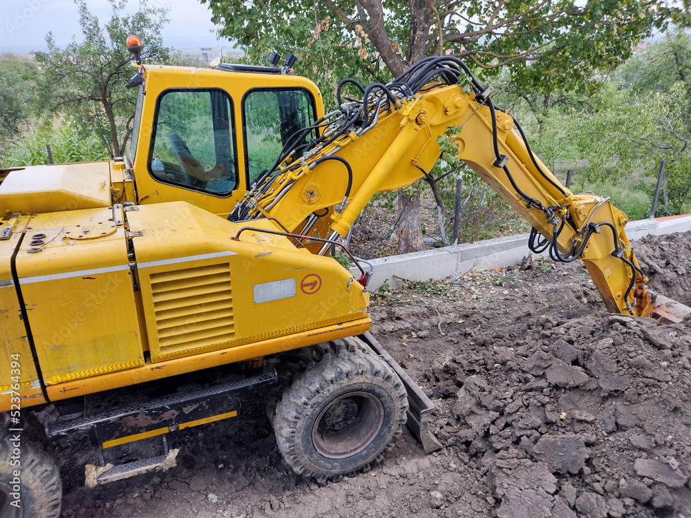 an excavator is stationed in an area where work is taking place an excavator is stationed in an area where work is taking place