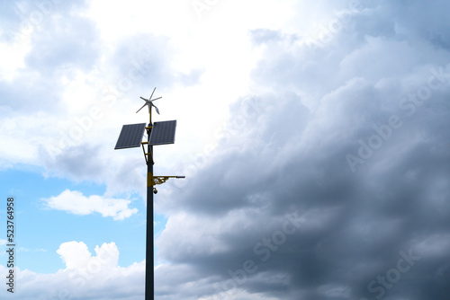 pole with solar panel and wind direction