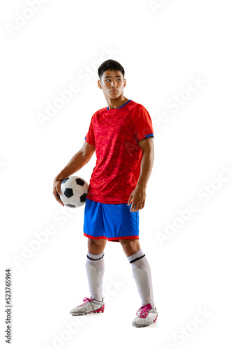 Full-length portrait of young man, football player posing with ball isolated over white studio background. Championship