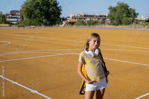 Smiling girl standing on playground photo