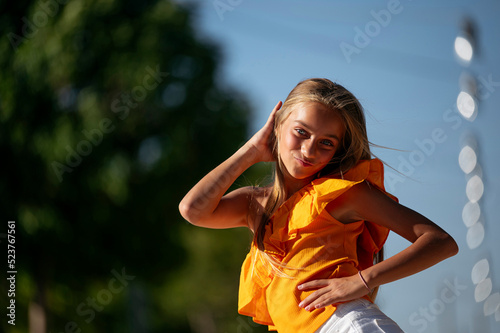 Joyful girl standing looking at camera on street photo