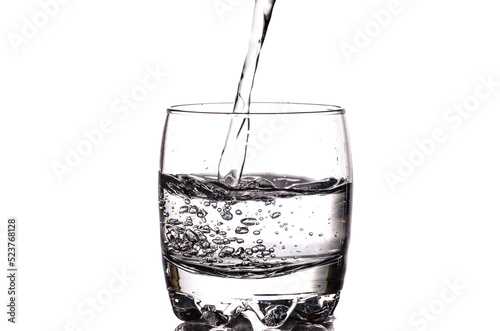 Pouring fresh water in a glass isolated on white background