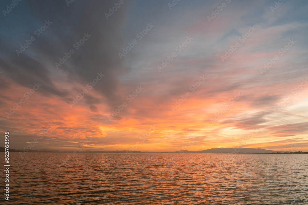 Sunset over the sea with cloudy and colorful beatiful sky view.