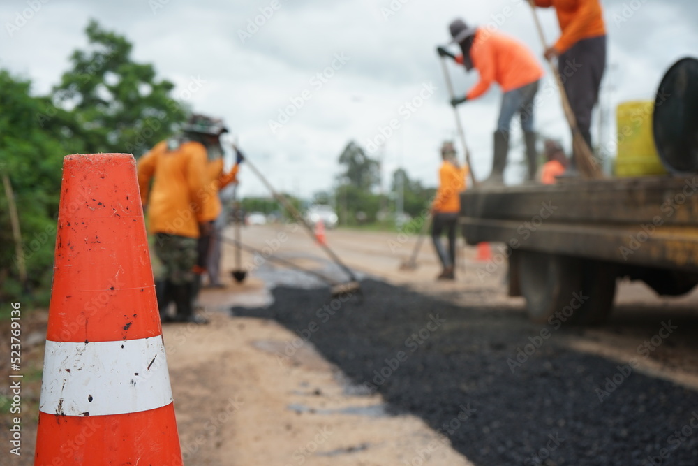 The image is blurred in the construction of asphalt road.