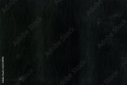 Black bright macro photo of texture of the genuine faux vegan leather. Fashion pattern and background. Leather with embossing.