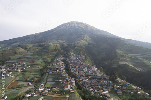 Nepal Van java, A small village known for its colorful houses on a slope set against a dramatic mountain view.
