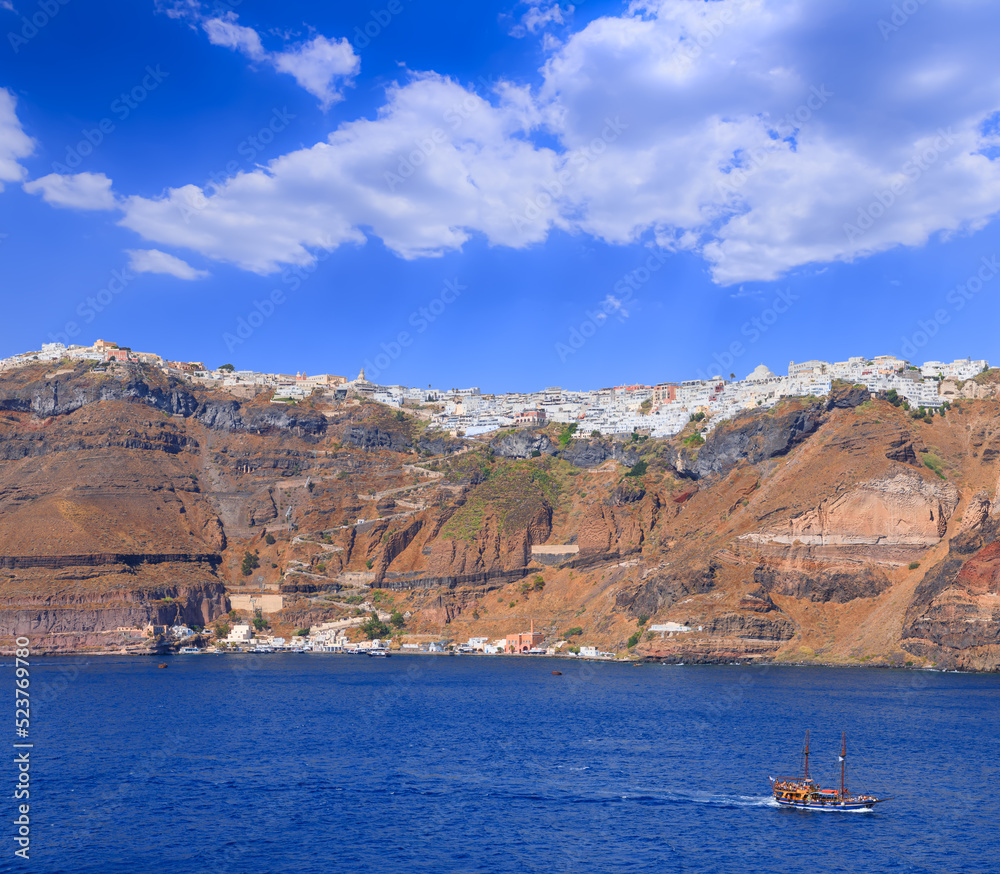 Townscape of Fira in Santorini, Greece. Thira stands on a caldera, the crater created by a violent volcanic eruption: the white houses cling to the cliff almost to its edge.