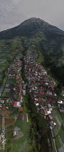 Nepal Van java, A small village known for its colorful houses on a slope set against a dramatic mountain view.