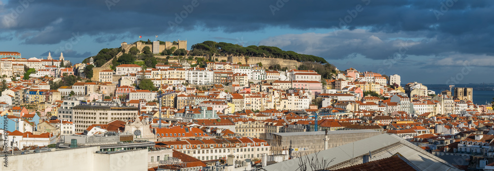 Lisbon, Portugal cityscape with historic Sao Jorge Castle and old town at sunset