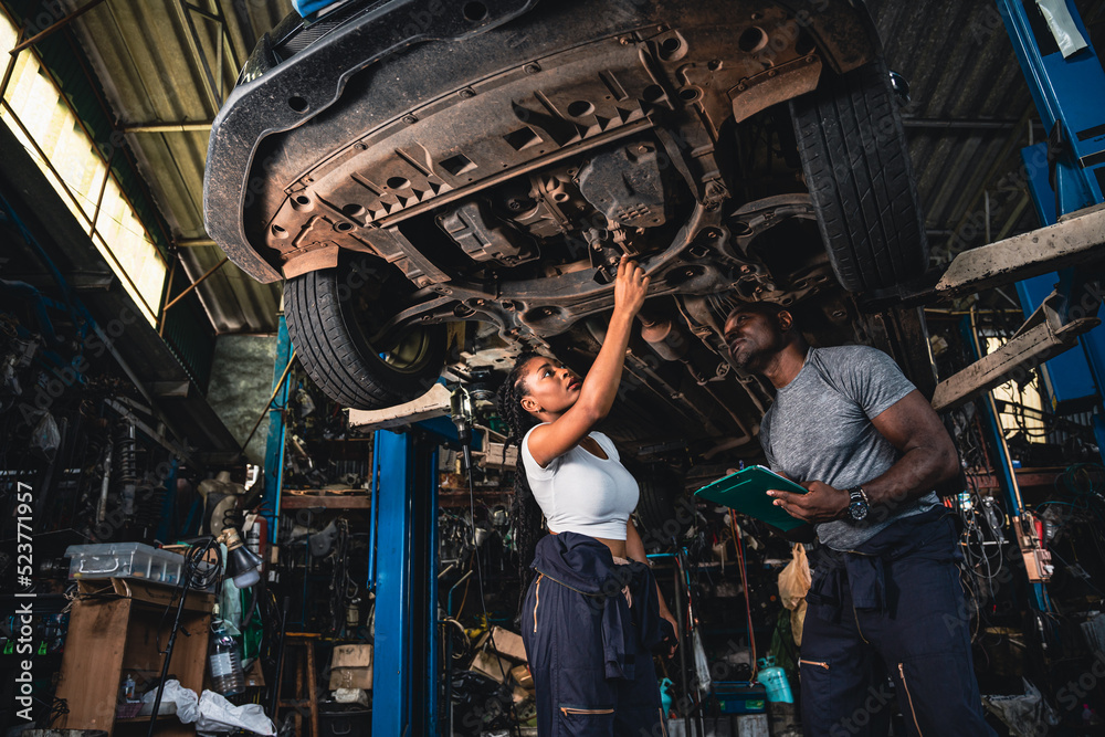 Professional mechanics are checking the car is suspension problems thoroughly.