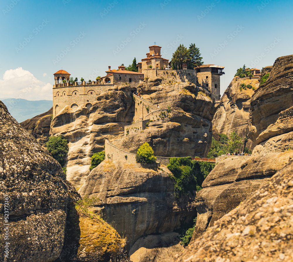 Square afar shot of one of the famous christian orthodox monasteries in Meteora, Greece. Midday. Beautiful sunshine. High quality photo