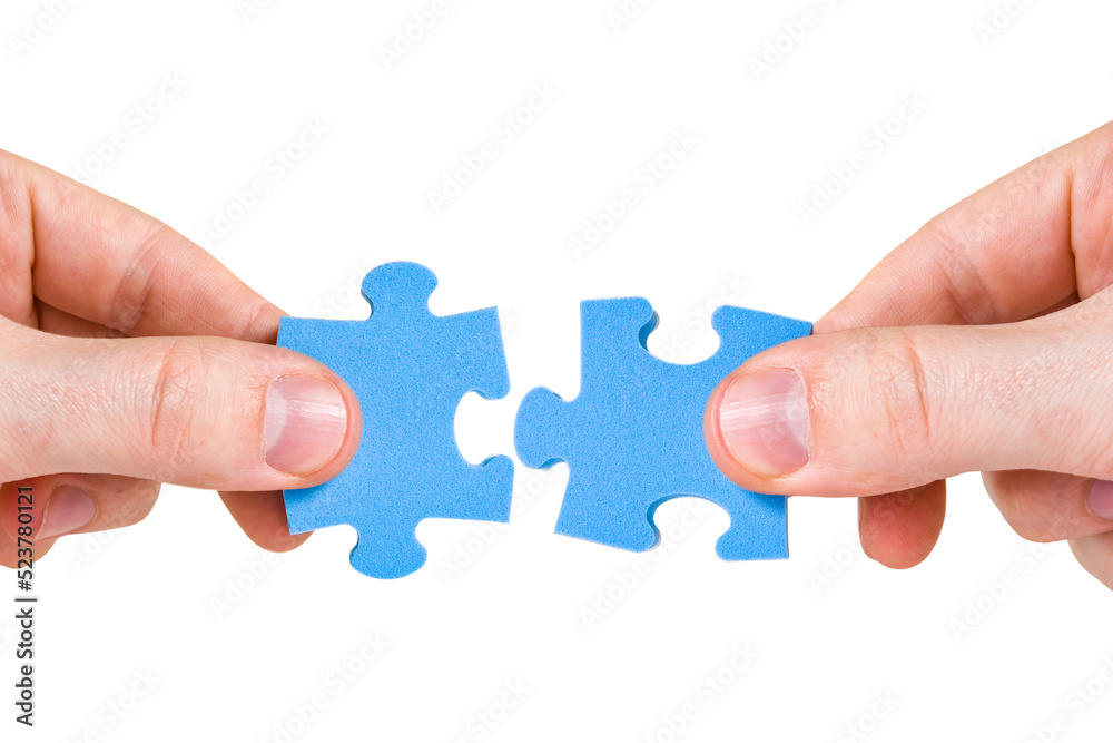 Two hands with different pieces of puzzle Two hands with different pieces of puzzle