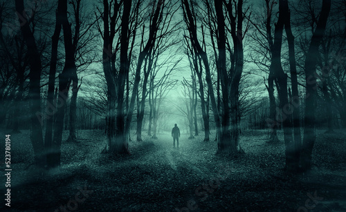 man on dark forest road at night, horror halloween landscape