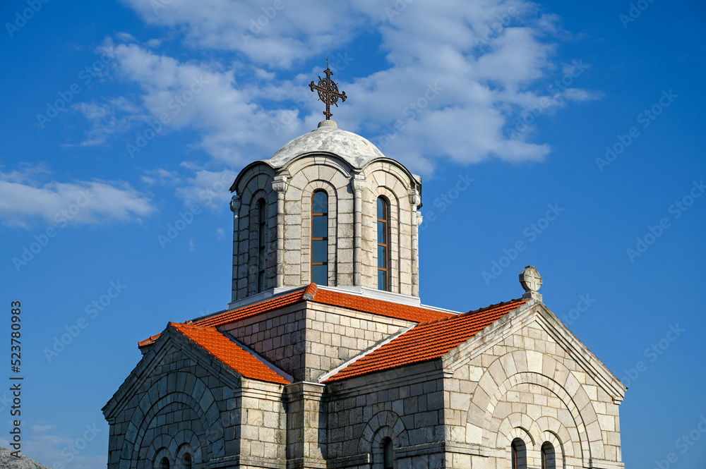 Old orthodox church. Bell tower and cross on church. 
