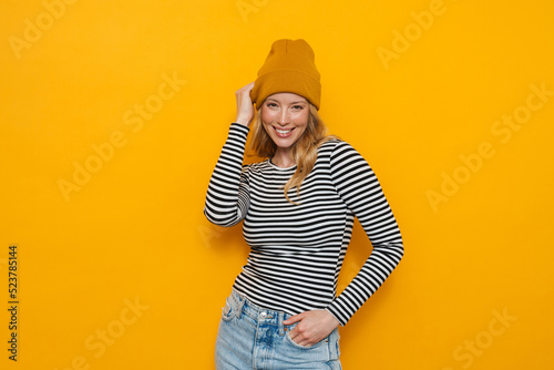 Young blonde woman wearing hat smiling and looking at camera