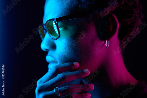  African American man portrait in sunglasses, isolated on purple background