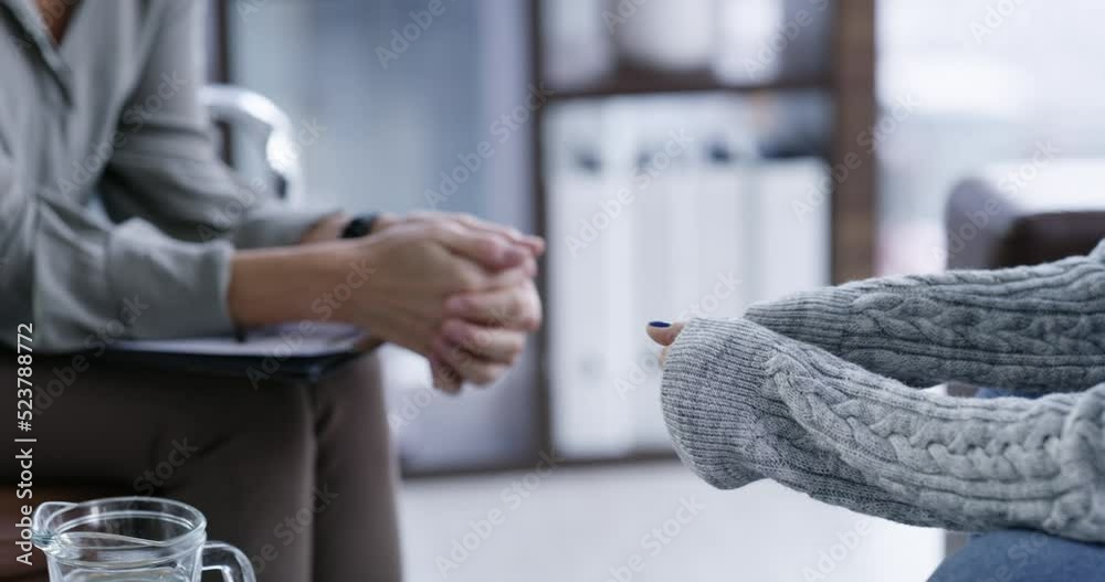 Patient talking in a therapy session to a supportive and trustworthy professional psychologist in her office. Kind and caring mature therapist listening carefully when counseling a stressed woman