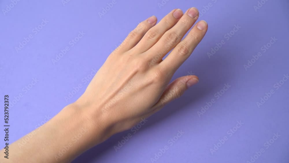 Peron spreading hand cream skincare on hands on a colorful background dermatology Peron spreading hand cream skincare on hands on a colorful background dermatology