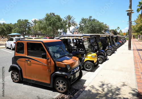 Line of golf carts parked in Sumter Landing, The Villages, Florida, USA. photo