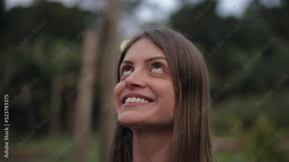 Meditative young woman closing eyes in meditation. Contemplative person opening eyes to sky with HOPE Meditative young woman closing eyes in meditation. Contemplative person opening eyes to sky with HOPE