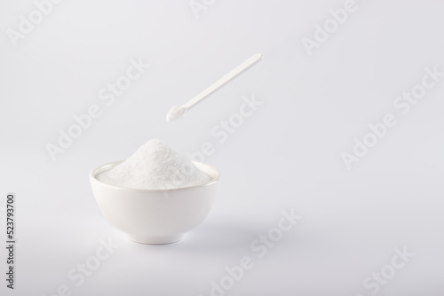Sugar substitute, Stevia in a white plate and in a small spoon. On a white background, a plate with a sugar substitute.