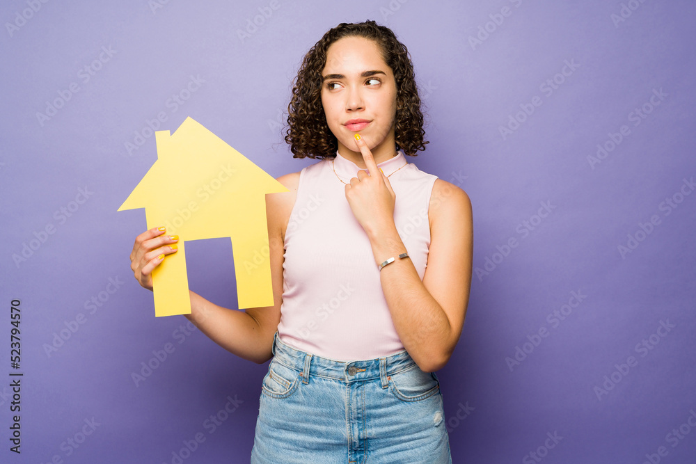 Smart woman thinking about buying or selling a house Smart woman thinking about buying or selling a house