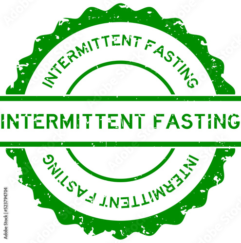 Grunge green intermittent fasting word round rubber seal stamp on white background