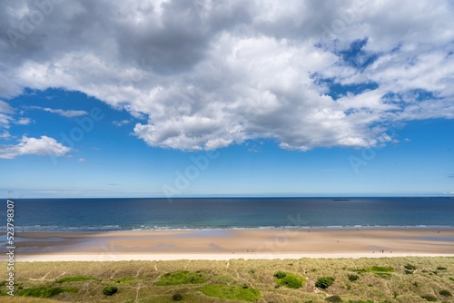 Fototapeta Naklejka Na Ścianę i Meble -  beach and clouds, tricolour of the sea, sandy beach and the field, background with copy space