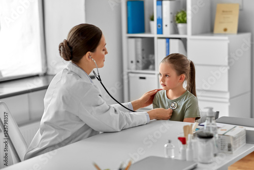 Fototapeta Naklejka Na Ścianę i Meble -  medicine, healthcare and pediatry concept - female doctor or pediatrician with stethoscope and little girl patient on medical exam at clinic