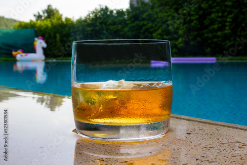 Whiskey with ice by the pool