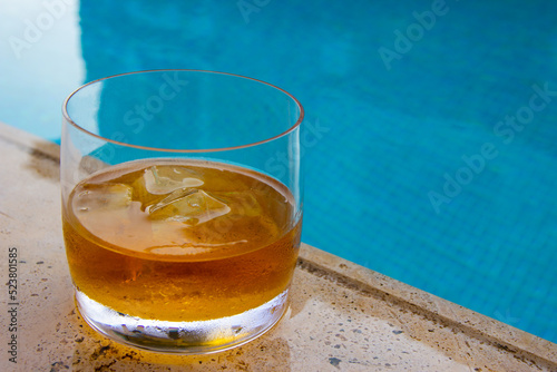 Whiskey with ice by the pool